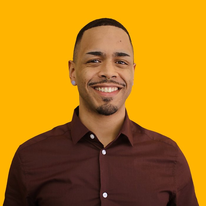 Portrait of a New Haven entrepreneur against a gold backdrop