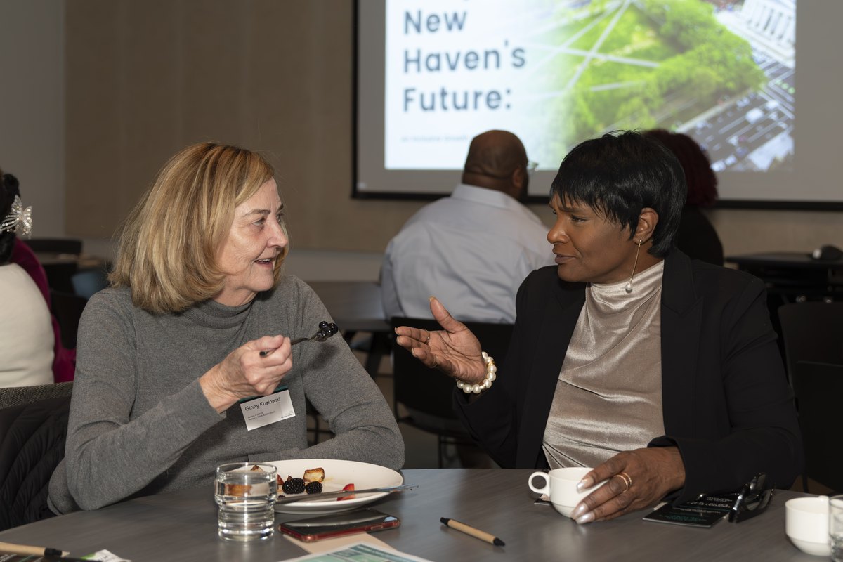 A business owner reviewing her books with an advisor over coffee